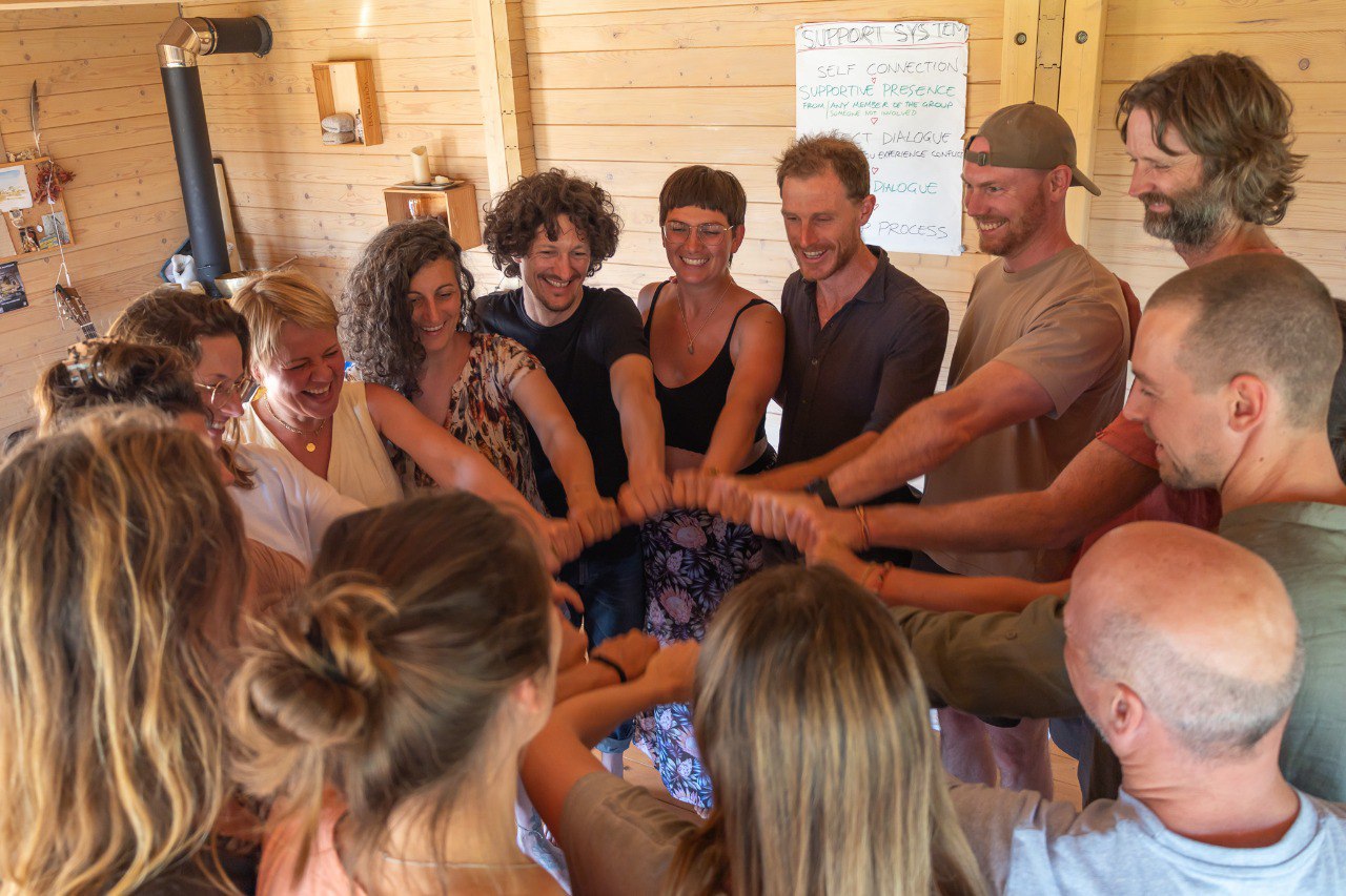 A circle of hands joined together during a group exercise, image 11 of 13